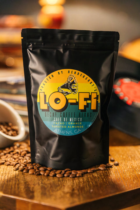 Lo-Fi Decaf Zero-Emission Micro-Roasted Sustainable Coffee | Premium Specialty Coffee | Best coffee in Athens GA | Front of black package sitting on table of coffee beans