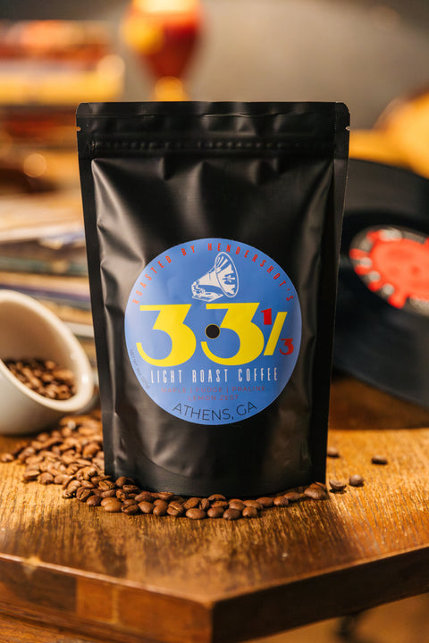 33 1/3 Zero-Emission Micro-Roasted Light Roast Coffee | Premium Specialty Coffee | Best coffee in Athens GA | Front of black package sitting on table of coffee beans